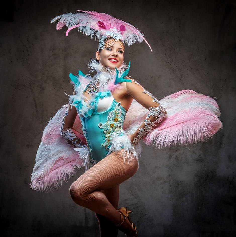 Beautiful girl in sumptuous carnival feather suit